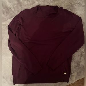 Purple Calvin Klein sweater.